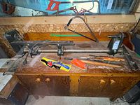 Lathe on cabinet with hand tools visible