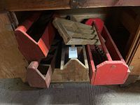 Group of red and natural wood totes under bench