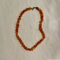 Full view of the Baltic Amber chip necklace laid flat showing the entire length and bead composition.