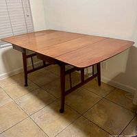 Table in drop leaf position with extension closed, full front view.