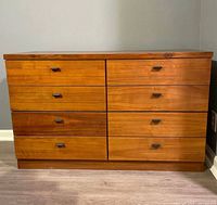 Front elevation of eight-drawer walnut dresser showing black bakelite pulls