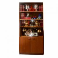 Front view of teak MCM storage cabinet filled with decorative items to show scale and shelving.