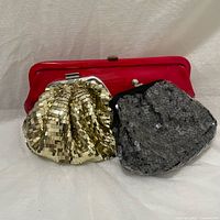 Three clutches together: gold sequin, black sequin, and red leather clutch