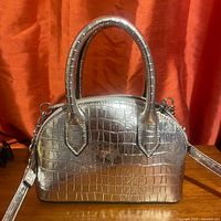 Silver embossed croc pattern handbag with top handles and detachable shoulder strap, silver-tone metal hardware, zip closure