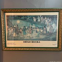 Full view of framed Diego Rivera poster featuring mural artwork with title and museum text beneath.