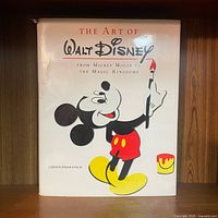 Front cover of the book showing Mickey Mouse painting with a brush and paint can.