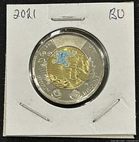 Obverse of 2021 Canadian two-dollar coin with colored brass-plated aluminum bronze center featuring insulin discovery theme, surrounded by nickel-plated steel ring.