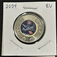 Obverse view of the coin showing the colored center with RCAF 100th Anniversary design, brass plated aluminum bronze, and nickle plated steel ring.