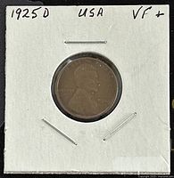 Photo of the 1925D US Lincoln One Cent coin in VF+ condition, mounted in a protective holder with handwritten annotations.