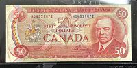 Front side of 1975 $50 Canadian banknote with portrait of William Lyon Mackenzie King and signatures.