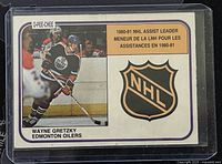 Front of 1981-2 O-Pee-Chee hockey card #383 showing Wayne Gretzky in Edmonton Oilers uniform and NHL Assist Leader title.