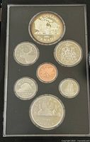 Photo of the coin set front side showing the 1981 silver double dollar and other coins with detailed designs.