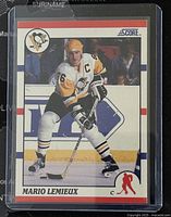 Front view of 1990-1 Score Mario Lemieux hockey card showing player in action with Penguins uniform and logos