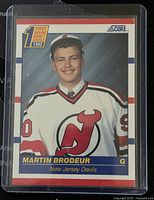 Front side of the 1990 Score Martin Brodeur rookie trading card showing Martin Brodeur in New Jersey Devils uniform, card numbered 439 in great shape encased in plastic sleeve.