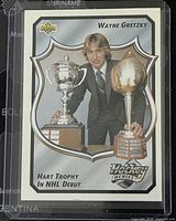 Front of Wayne Gretzky 1992-3 Upper Deck hockey trading card showing photo of Gretzky with NHL trophies.