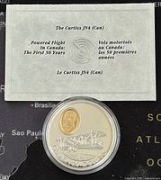 Certificate with title and aviation commemorative details placed behind the coin in a protective case.