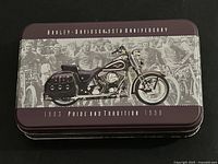 Collector's tin with image of Harley-Davidson motorcycle on the lid and vintage motorcycle riders background
