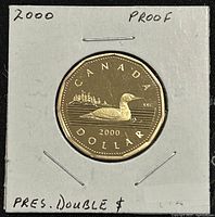 Reverse side of 2000 Canadian proof loonie coin showing common loon on water, date 2000 and inscriptions
