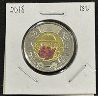 Obverse showing colorized poppy and 'REMEMBRANCE' inscription with date 2018, grading 'BU' written on holder.