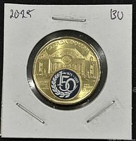 Front side of the 2025 Canadian Supreme Court 150th anniversary loonie showing Supreme Court building and colorized emblem.