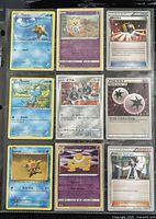 Front side of nine assorted Pokémon trading cards featuring Staryu, Togetic, Ultra Ball, Froakie, Japanese Pokémon card with three small Pokémon, Double Colorless Energy, Hypno, and Professor Sycamore in protective sleeve.