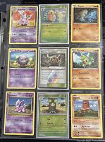 Front side of 9 Pokémon cards featuring various Pokémon and a Trainer card in protective sleeves.