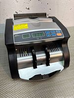 Front view of the RBC-1100-CA bill counter showing control panel and bill feeder.