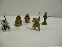 Group shot of all five metal figurines