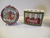 Alarm clock and toothbrush holder side by side