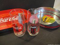 Overall view: tray, two glasses, napkin holder