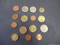 All 15 Euro coins arranged on dark surface