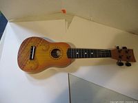 Full view of ukulele front showing body, neck, headstock