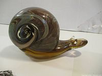 Side view of glass snail showing swirl shell pattern