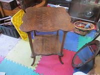 Full view of oak side table showing top and lower shelf