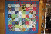 Full view of patchwork quilt showing pattern and dimensions