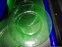 Stacked green uranium glass plates showing spiral pattern