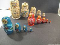 All three nesting doll sets arranged in descending order