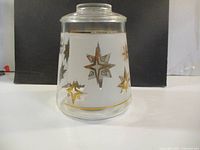 Full view of jar front showing starburst motifs and lid