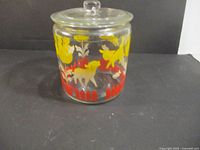 Front view of glass biscuit jar showing animal and flower graphics