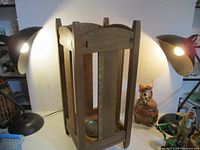 Full view of wooden umbrella stand with surrounding items
