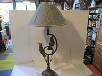 Full view of lamp with shade showing cockatoo base and height