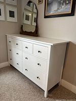 Front view of the Ikea GULLABERG dresser showing 8 drawers with black knob handles in white finish.