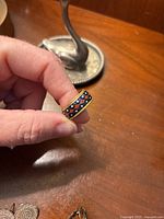 Front and top angle view of the vintage band ring showing colorful enamel and gold-tone metal design details.