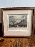 Framed print in wooden frame showing the full artwork and frame