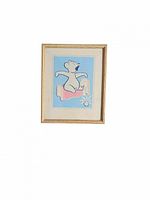 Framed 1943 vintage nursery picture showing bear sitting on pink bed with blue background. Photo taken from distance to show full frame and artwork.
