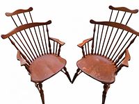 Pair of vintage Whitney solid maple fan back Windsor arm chairs, showing front and angled views to display shape, armrests, and wear on seats.
