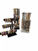 Photo showing multiple black velvet T-bar jewelry stands displaying colorful bracelets including stretchy bead, charm, and gemstone bead bracelets.