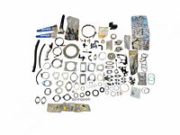 Full view of various GE Motors car parts including clamps, gaskets, O-rings, tubes, and ice scrapers laid out neatly.