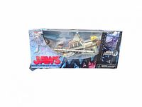 Front view of the Jaws toy in original box with shark and boat visible