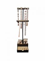 Rose quartz jewelry including bracelets and pendants displayed on a black stand, with raw stones in small bags and loose pieces below.